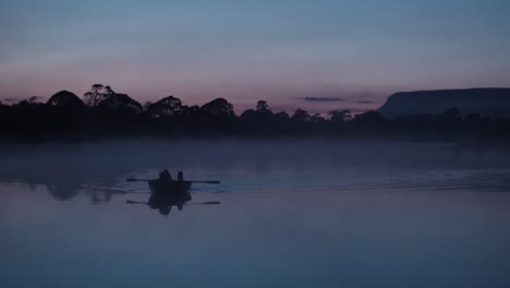 Rowing-bow-on-fog-covered-river-at-Dusk
