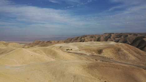 fly-over-sand-dunes-and-zoom-at-an-isolated-ancient-ruin-in-the-desert,-Israel