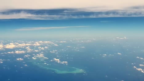 Amazing-aerial-view-of-atoll-of-turquoise-Maldives-archipelago-and-clouds