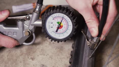 Bike-repair-kit-and-inflating-empty-bike-tire-with-compressor-and-manometer