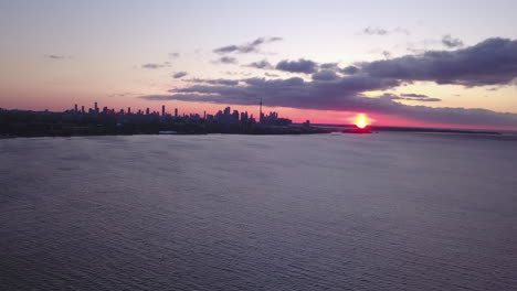 Aerial-view-across-Lake-Ontario-of-Toronto's-skyline-at-dawn