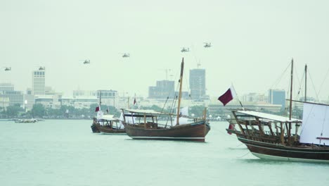 Dhow-boats-in-Qatar-with-Military-Helicopters-in-the-distance