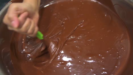Hand-Mixing-Chocolate-in-large-metal-bowl-close-up
