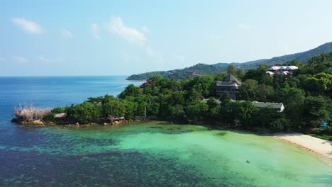 Thailand-islands,-aerial---tropical-coastal-house-hidden-in-the-exotic-forest-with-private-sandy-beach