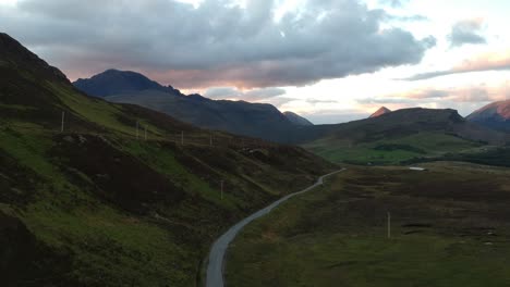 Panning-drone-shot-of-Scottish-winding-road-with-mountains