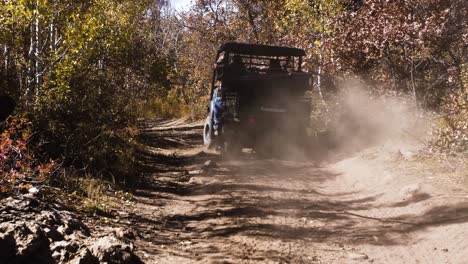 Four-Wheeler-or-Mule-Type-Vehicle-Driving-Down-Mountain-Trail