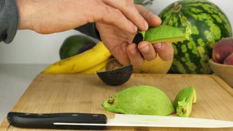 Avocado-skin-is-peeled-off-a-chunk-of-fresh-creamy-fruit