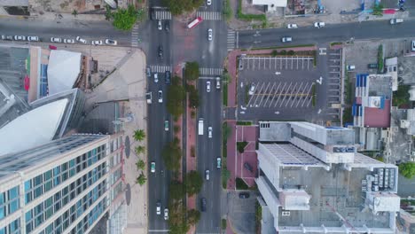 Birdseye-view-of-cars-moving-through-busy-city-streets-in-Santo-Domingo-Dominican-Republic-drone-aerial