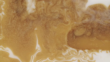 Mesmerizing-shot-of-a-golden-liquid-forming-abstract-forms-and-patterns