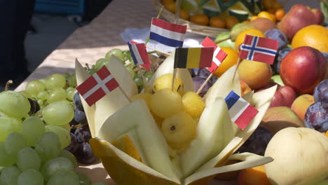 Arranged-fruit-on-the-table-and-flags-of-German,-Russian,-Swiss,-English-and-French
