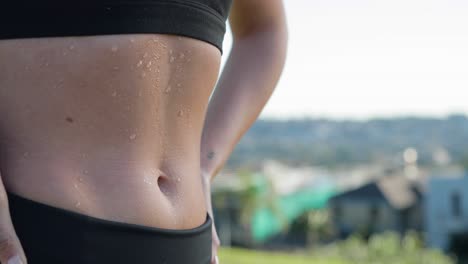 Female-stomach-with-sweat-dripping-down-abs