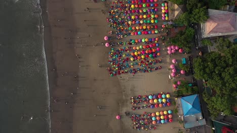 Aerial-high-angle-view-of-the-Beach-With-Parasols-And-Beanbags,-double-six-beach,-Kuta-Bali-Indonesia