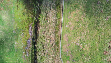 Birdseye-view-of-a-section-of-Hadrians-wall,-clouds-shadow-in-shot