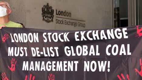 Solidarity-protestors-outside-London-Stock-Exchange-hold-banners-that-say,-“De-list-Global-Coal-Management-now”-on-the-14th-anniversary-of-three-killed-during-demonstrations-in-Phulbari,-Bangladesh