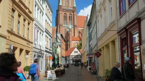 Aug-2020,-Schwerin,-Germany:-people-walking-in-a-narrow-alley-near-in-the-old-town-close-to-Schwerin-Lutheran-Cathedral