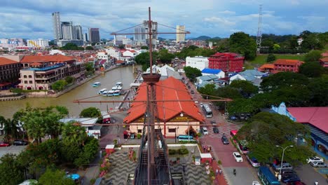 Epic-aerial-shot-of-historic-war-ship,river-and-old-buildings-in-malacca,Malaysia,Asia
