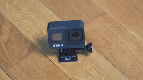 Mysterious-close-up-shot-of-GoPro-Hero-8-black-action-camera-on-wooden-floor