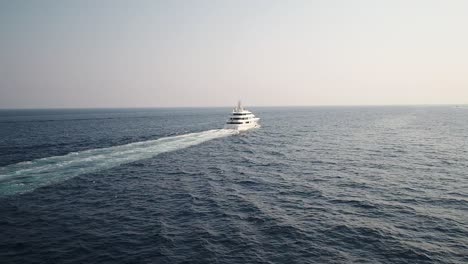 Aerial-over-a-large-luxury-cruise-ship-on-a-blue-sea,-orbit-dolly-in