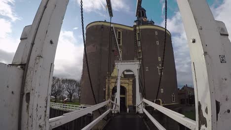A-drawbridge-in-front-of-the-Drommedaris,-the-most-famous-building-of-the-city-of-Enkhuizen
