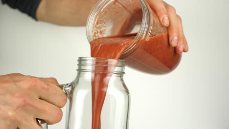 A-rich-red-healthy-smoothie-is-poured-into-a-trendy-kilner-jar-with-handle