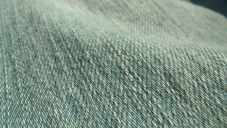 Extreme-close-up-along-blue,-denim-fabric