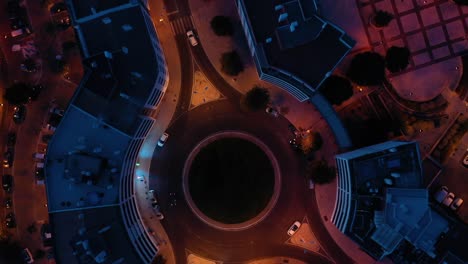 Aerial-top-view-of-cars-in-roundabout-in-lisbon-city,-blue-and-orange-colors