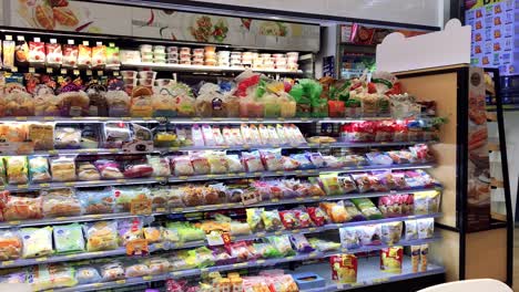Food-and-snack-products-on-a-big-shelf-in-7-11-store