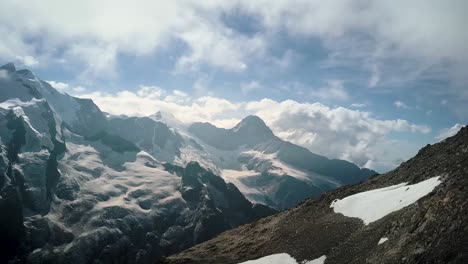 Arerial-dolly-shot-of-the-top-of-europe-mountain-range-with-the-Eiger-and-Mönch-peak-in-the-Swiss-Alps