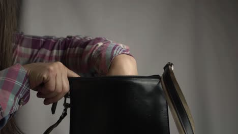 Woman-searching-in-handbag-medium-shot