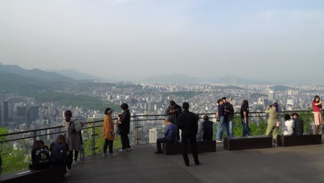 Tourists-take-pictures-on-Seoul-city-background-from-Namsan-mountain-N-tower