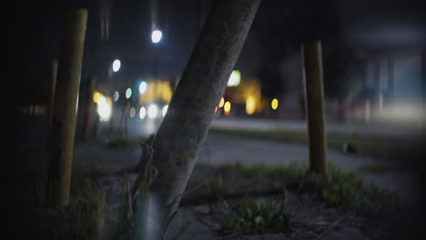 Old-Yellow-Parking-Posts-Close-Up-at-Night-as-Cars-Pass-in-Anamorphic