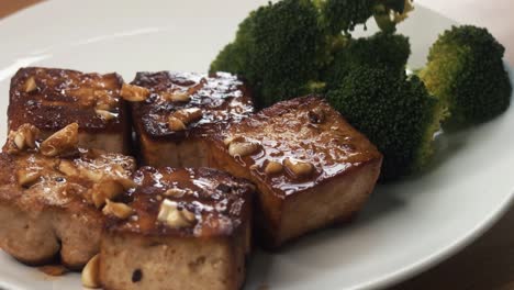 Close-Shot-of-Plating-Up-a-Dish-of-Tofu-and-Broccoli-in-the-Kitchen