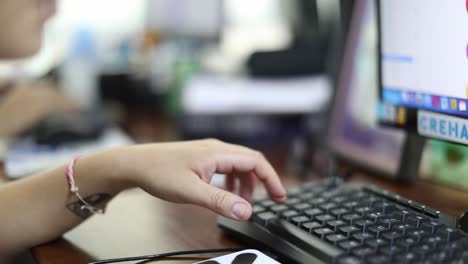 Hands-of-office-workers-seen-as-employees-work-on-a-computer