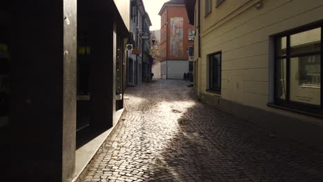 A-small-dangerous-alley-made-of-stone-for-ages-ago-with-sunshine-and-building-in-Feldkirch-Austria