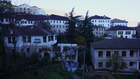 Hotels-and-guest-houses-in-stone-city-of-Gjirokastra-with-white-facades-at-morning