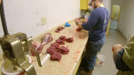 Three-hunters-processing-their-catch-of-wild-game