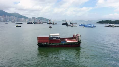 Small-Feeder-class-Container-ship-in-Hong-Kong-bay,-Aerial-view