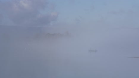 fisherman-boat-foggy-lake-morning-slow-motion