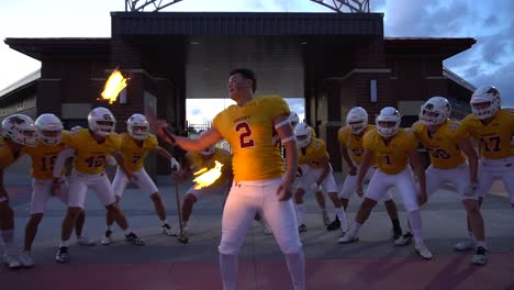 Football-team-getting-motivated-with-fire-spinning-player-before-a-game