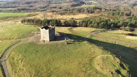 Ancient-hillside-Rivington-tower-Lancashire-reservoir-countryside-aerial-tilt-down-over-view