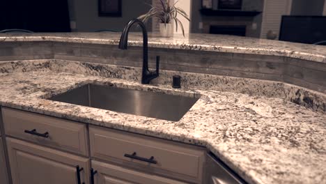 Contemporary-kitchen-cabinet-design-with-counter-top-made-of-granite-stone,-under-mount-sink-and-faucet