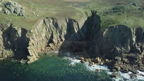 Half-Of-RMS-Mulheim-Shipwreck-In-An-Island-Inlet-At-Land's-End-Cornwall-England---aerial-shot