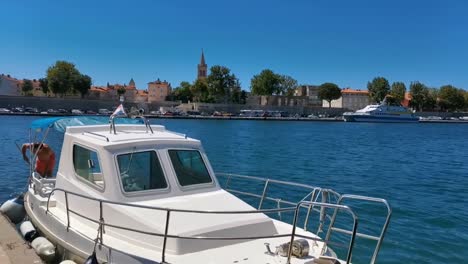 Summer-of-2020-in-Zadar,-Croatia-blue-sky-and-Adriatic-Sea-with-view-over-towns-panorama,,-fishing-boat-and-jet-ski-passing