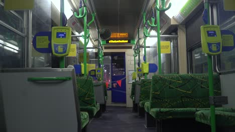 An-empty-tram-rolls-through-Melbourne,-Australia-during-the-nightly-coronavirus-curfew-that-forces-people-to-stay-home-and-leaves-the-streets-and-public-transport-deserted
