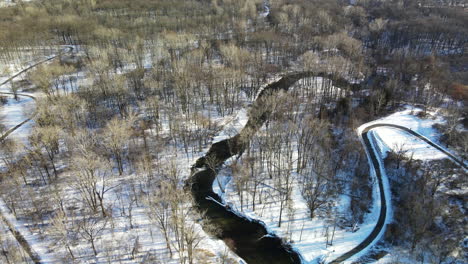 Aerial-footage-of-winter-forest-and-stream-in-Michigan