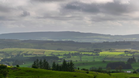 Time-lapse-of-countryside-landscape-with-hills-and-fields-on-a-cloudy-dramatic-autumn-day-in-rural-Ireland