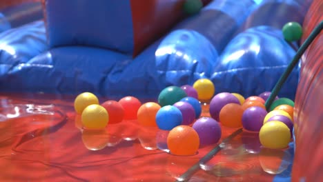 Colourful-balls-rolling-into-a-air-slip-and-slide-toy