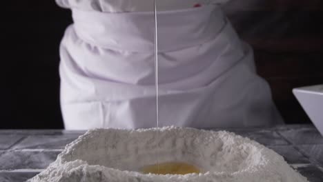 chef-pouring-an-egg-onto-flour-in-slow-motion