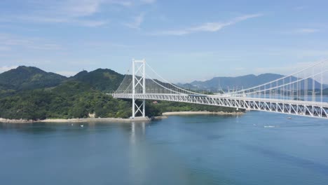 Aerial-tilt-reveals-warm-island-scene-at-bridge-in-Hiroshima-Japan