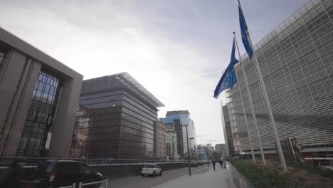 Wide-angle-shot-of-the-European-Union-flags-flying-in-front-of-the-Shuman-European-Quarter